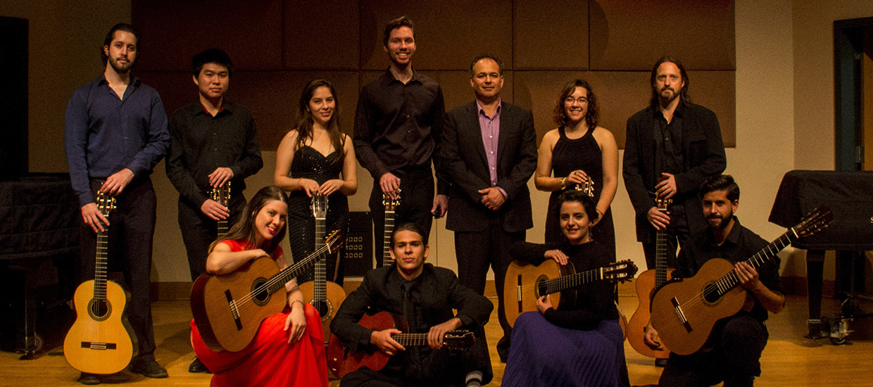 Classical Guitar Ensemble pose for a group picture with their guitars