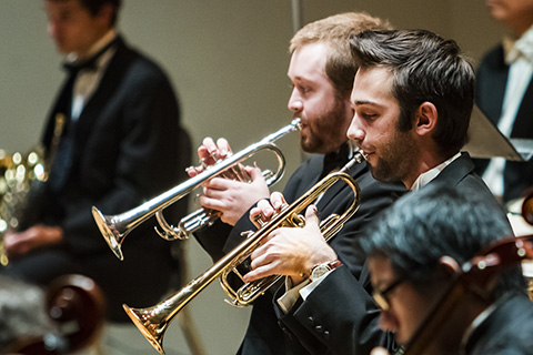 Trumpet players are performing during an event at the University of Miami