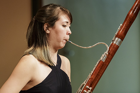 A classical musician plays the bassoon 